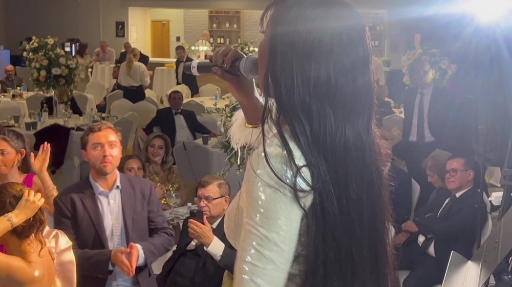 Live singer performing with wireless microphone at a wedding