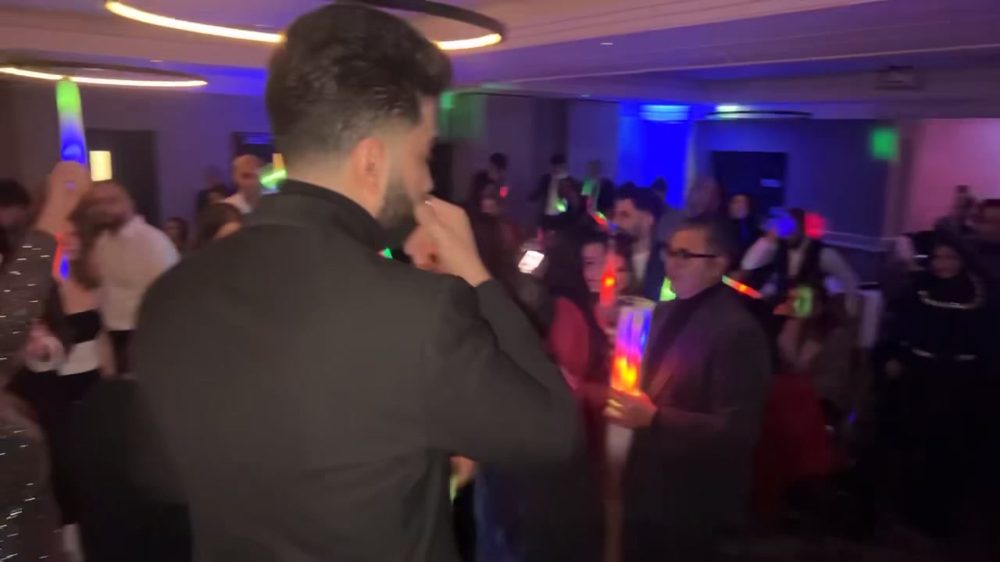 Party guests dancing with PA and lighting setup